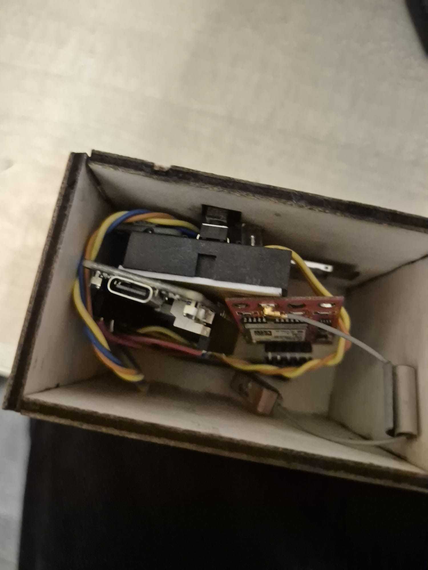 Finished enclosure, side view showing internal components fitted inside the laser-cut wooden case